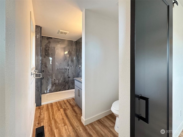 bathroom with toilet, a shower, wood-type flooring, and vanity