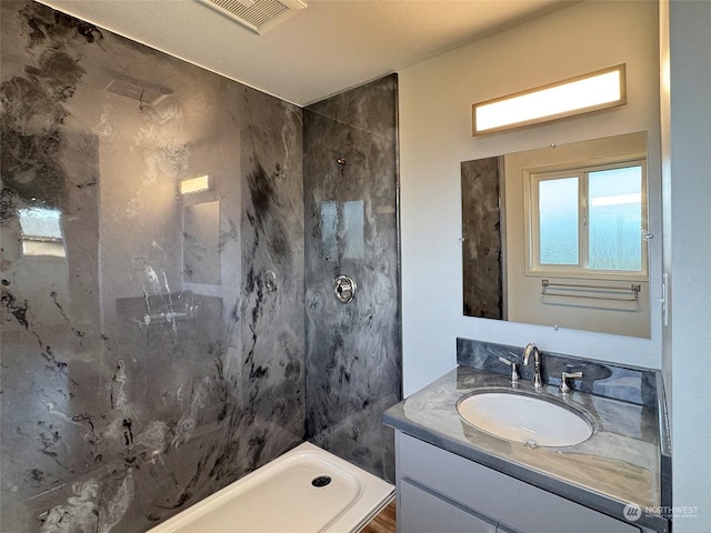 bathroom with walk in shower, a water view, and vanity