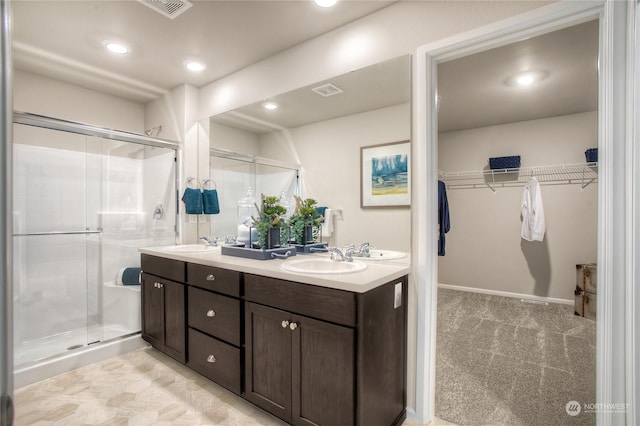 bathroom with walk in shower and vanity