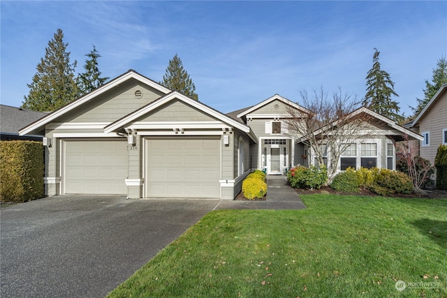 view of front of house featuring a garage and a front yard