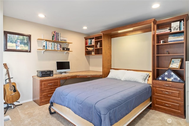 carpeted bedroom with built in desk