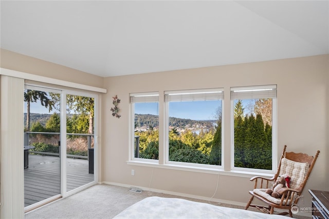 interior space with light colored carpet and access to exterior