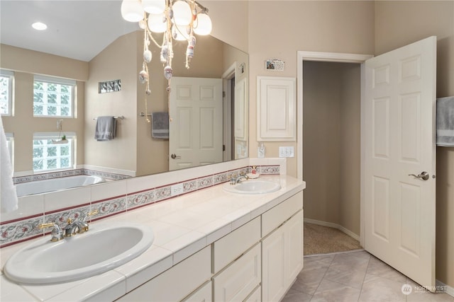 bathroom with tile patterned flooring, vanity, and a notable chandelier