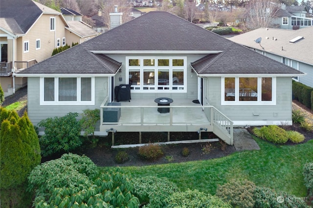 back of house featuring a yard and a deck