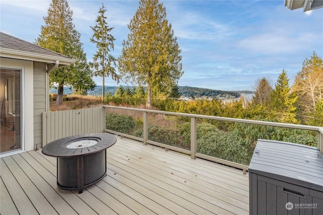 wooden terrace with a fire pit