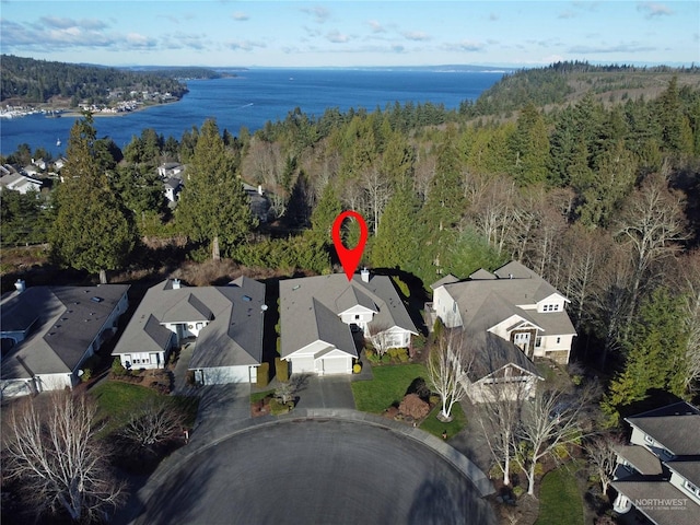 birds eye view of property with a water view