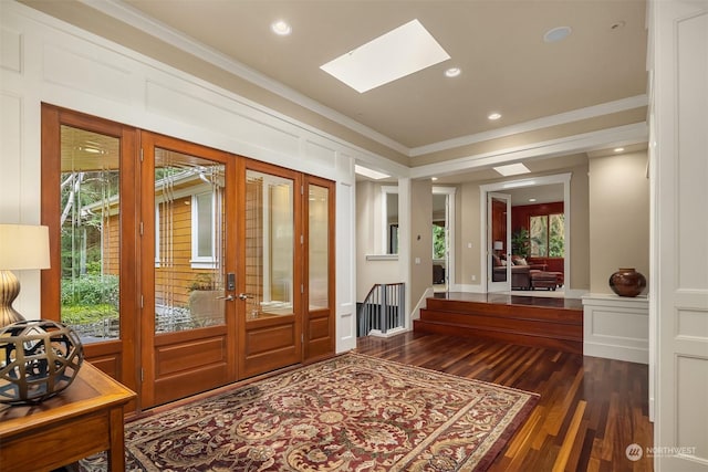 entryway featuring a skylight, dark wood-type flooring, french doors, and crown molding