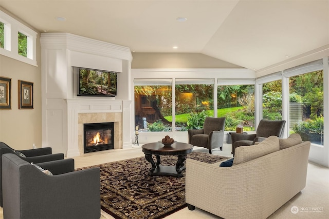 carpeted living room featuring lofted ceiling and a premium fireplace