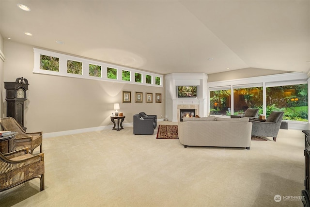 living room with carpet floors, vaulted ceiling, and a fireplace