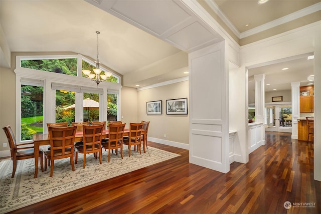 dining area with vaulted ceiling, dark hardwood / wood-style floors, an inviting chandelier, and ornate columns