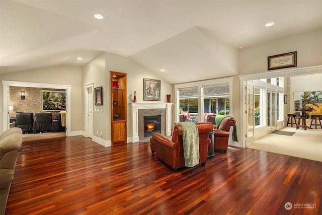 living room with vaulted ceiling, a fireplace, and dark hardwood / wood-style flooring