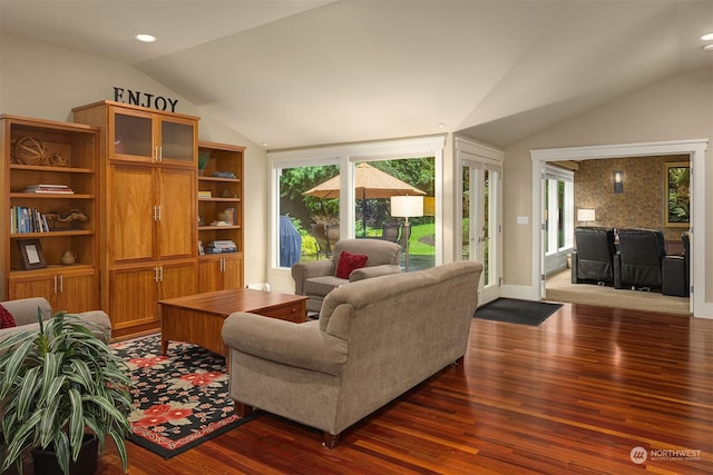 living room with dark wood-type flooring, vaulted ceiling, and plenty of natural light