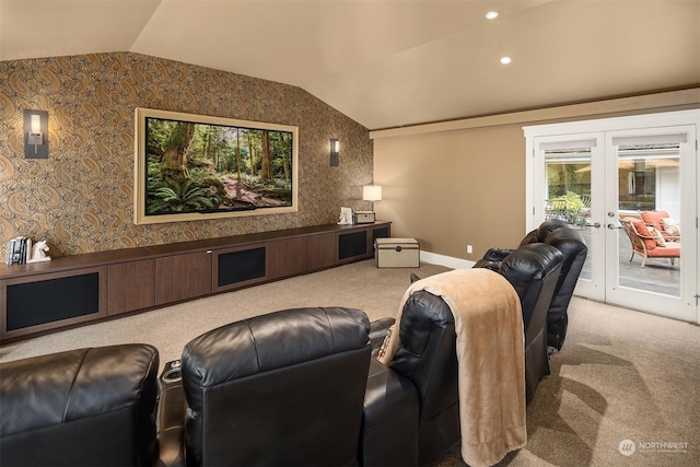 carpeted home theater with french doors and vaulted ceiling