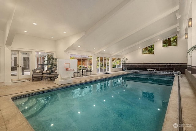 view of swimming pool featuring french doors