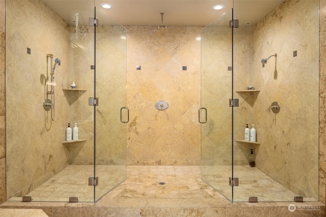 bathroom featuring a shower with door