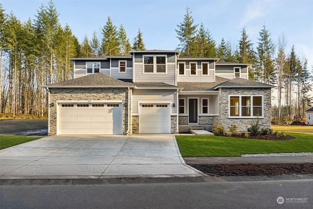 view of front of home with a front yard and a garage