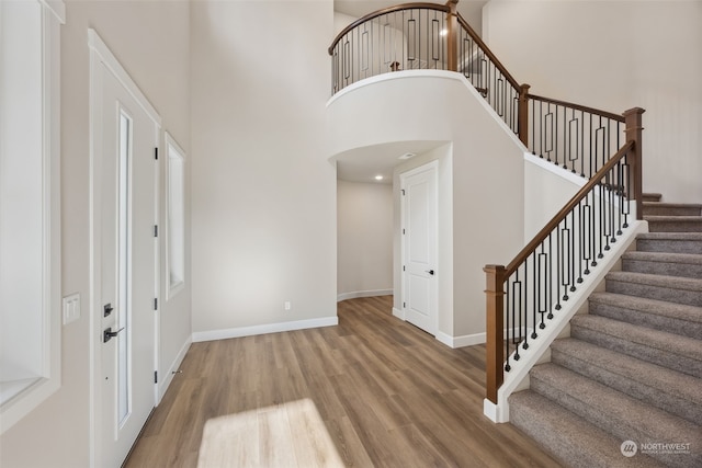 entryway with hardwood / wood-style flooring and a high ceiling