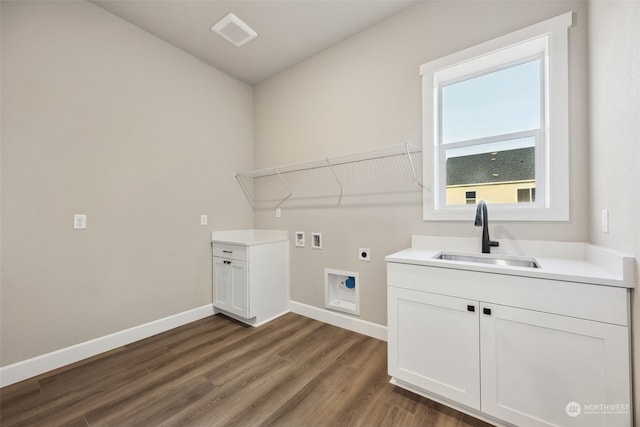 clothes washing area featuring electric dryer hookup, dark hardwood / wood-style flooring, hookup for a washing machine, and sink