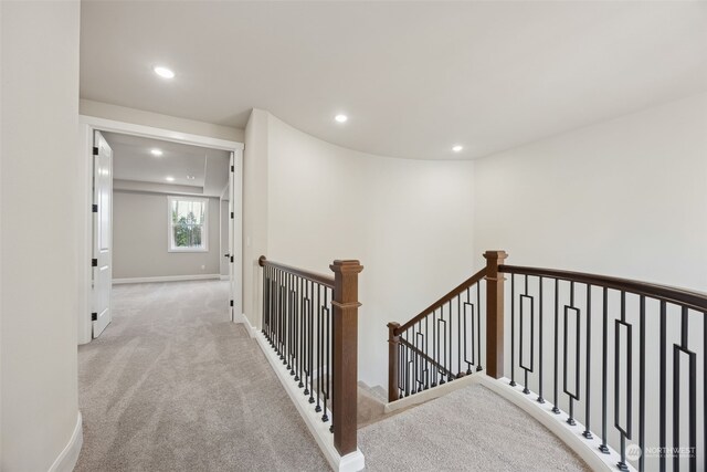 hall featuring light colored carpet