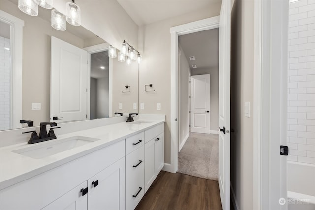 bathroom featuring shower / bathtub combination, wood-type flooring, and vanity