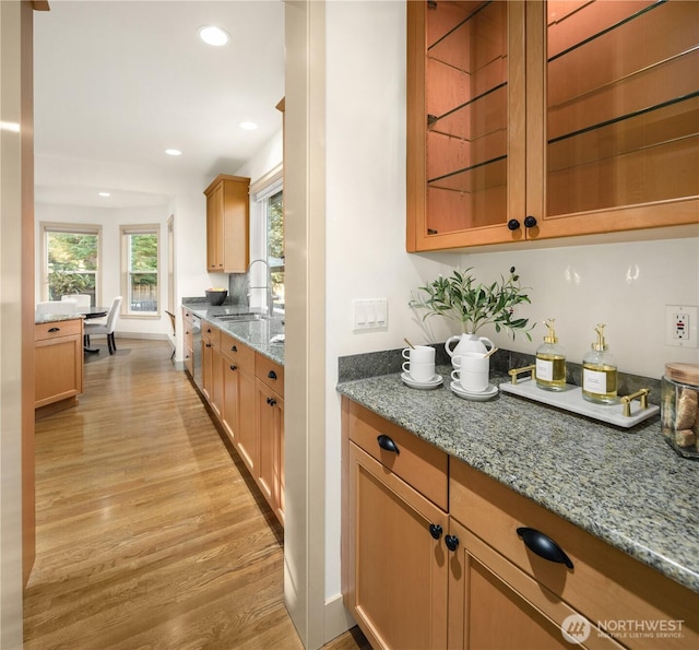 bar featuring stainless steel dishwasher, recessed lighting, a sink, and light wood finished floors