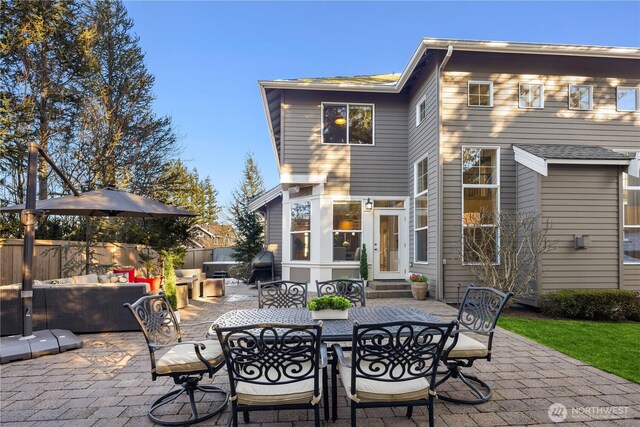 view of patio / terrace featuring entry steps, outdoor dining area, an outdoor hangout area, and fence