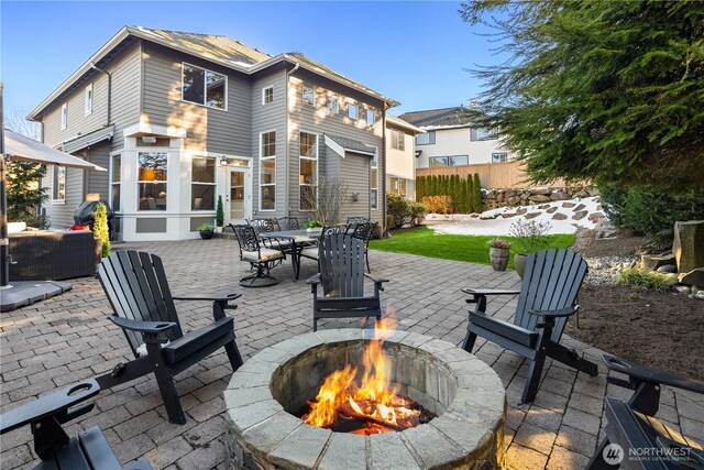 view of patio featuring fence and a fire pit