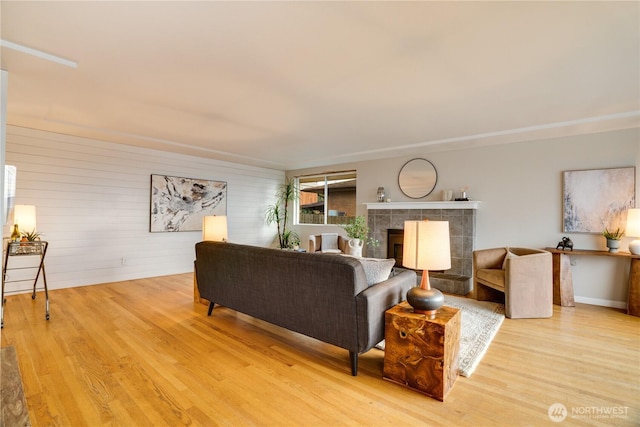 living area with a fireplace and light wood-type flooring