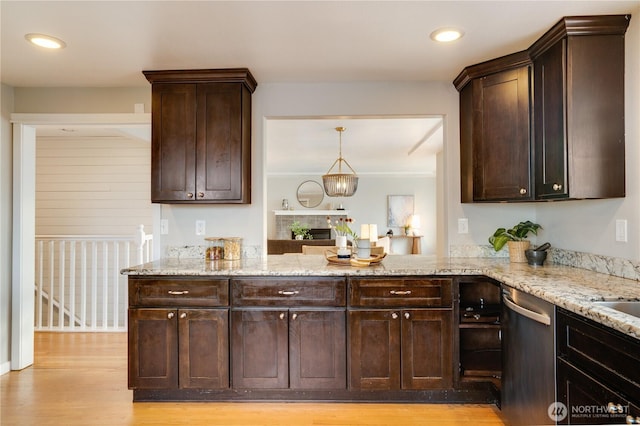 kitchen with dark brown cabinets, dishwasher, light wood-style flooring, and light stone countertops