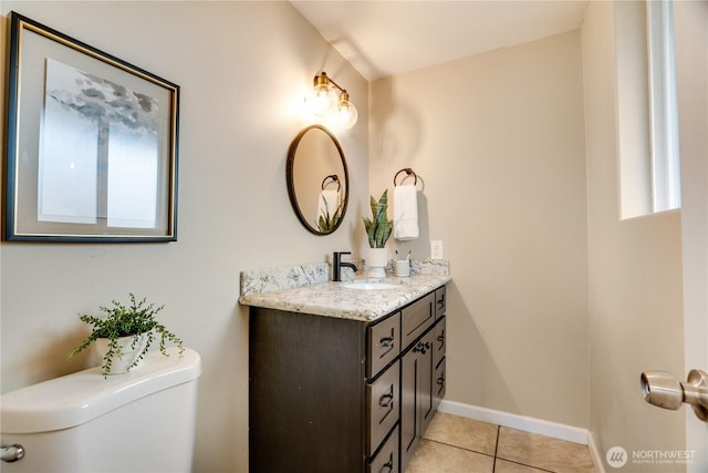 bathroom with vanity, tile patterned floors, toilet, and baseboards