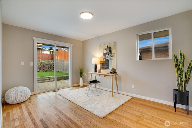 interior space with wood finished floors and baseboards