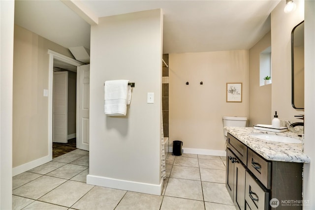 bathroom with tile patterned flooring, baseboards, toilet, vanity, and a shower