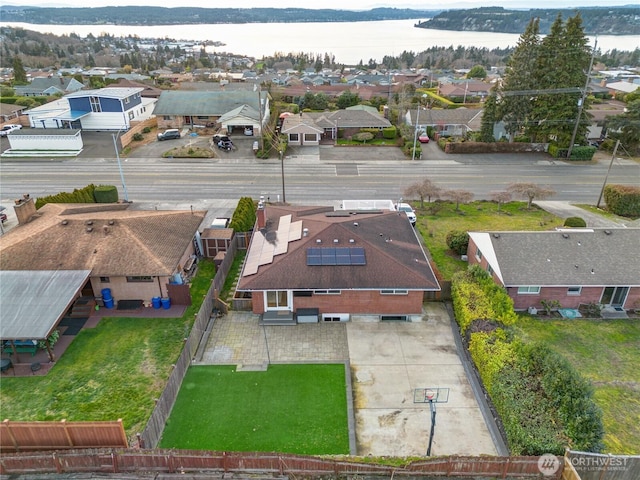 bird's eye view with a residential view and a water view