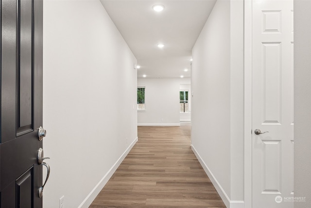 hallway with light hardwood / wood-style flooring