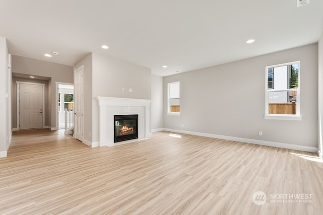 unfurnished living room with light wood-type flooring