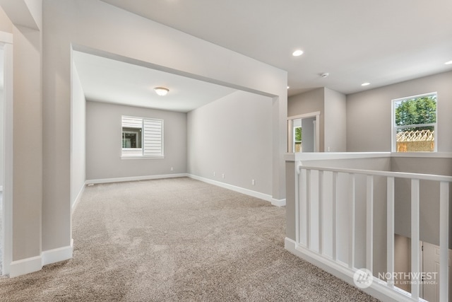 carpeted empty room featuring a wealth of natural light