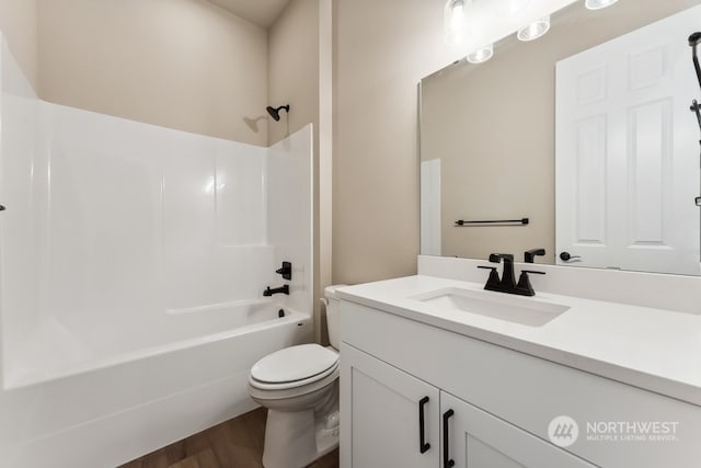 full bathroom with vanity, hardwood / wood-style flooring, shower / tub combination, and toilet