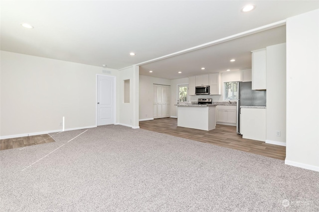 unfurnished living room with light carpet