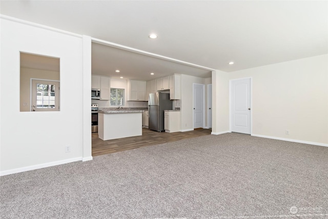 unfurnished living room with carpet flooring