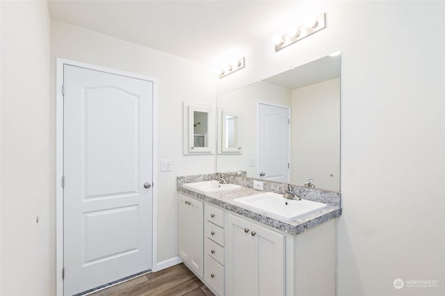 bathroom with hardwood / wood-style flooring and vanity