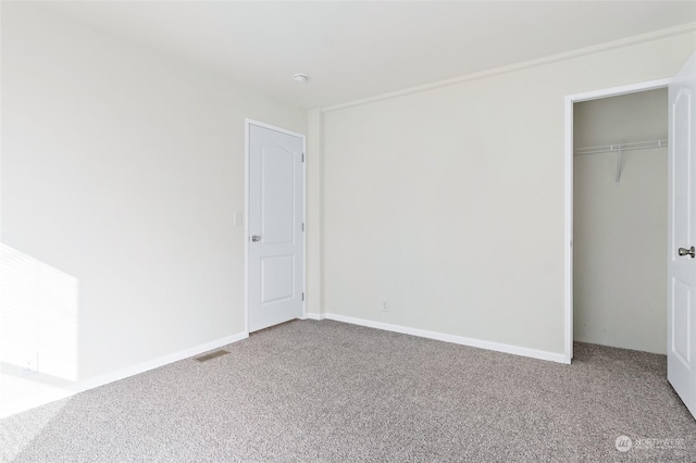 unfurnished bedroom with a closet and carpet flooring