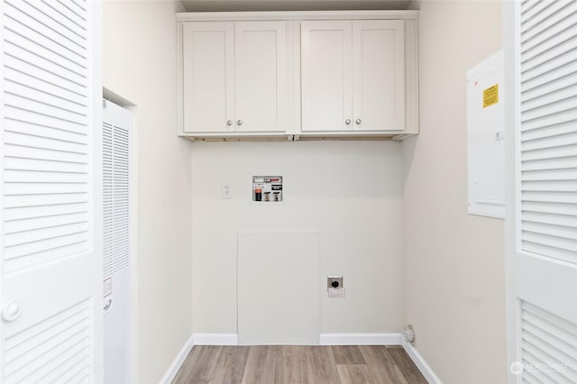 laundry room with cabinets, electric dryer hookup, washer hookup, and light hardwood / wood-style floors