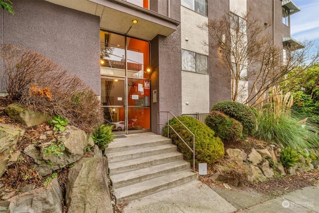 property entrance featuring stucco siding