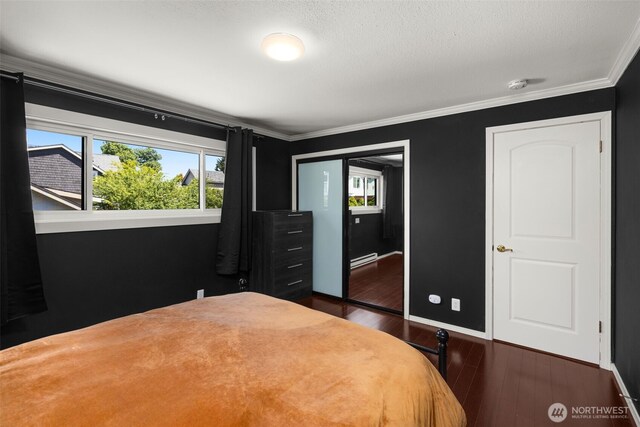 750 Crockett St Unit 403, Seattle, WA 98109 - bedroom featuring multiple windows, dark wood-style floors, ornamental molding, a closet, and baseboard heating