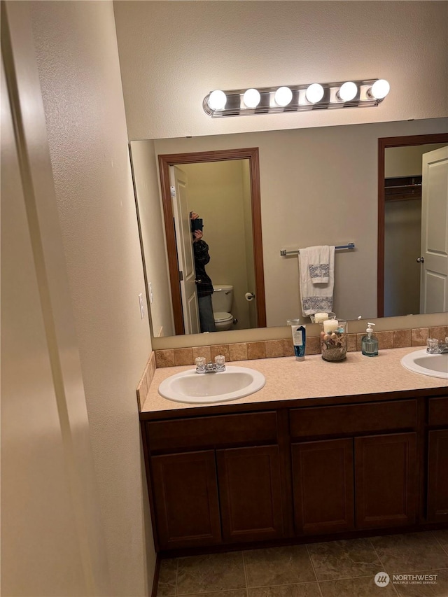 bathroom featuring toilet and vanity