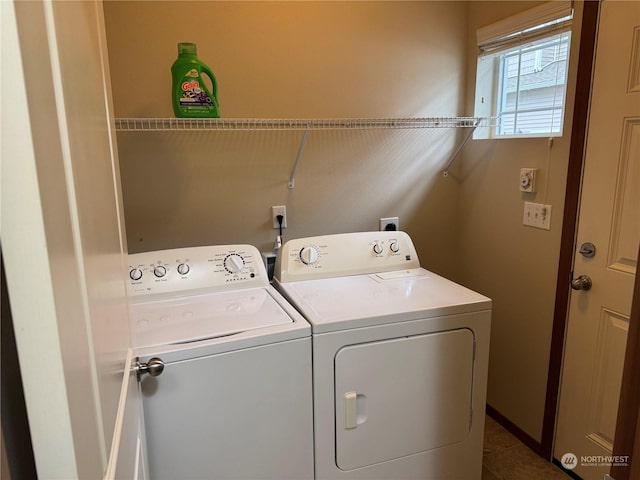 clothes washing area with separate washer and dryer and tile patterned floors