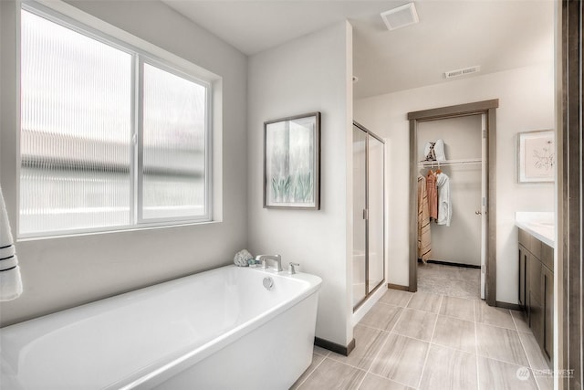 bathroom featuring vanity and shower with separate bathtub