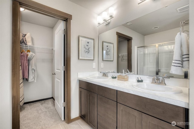 bathroom featuring vanity, tile patterned floors, and an enclosed shower