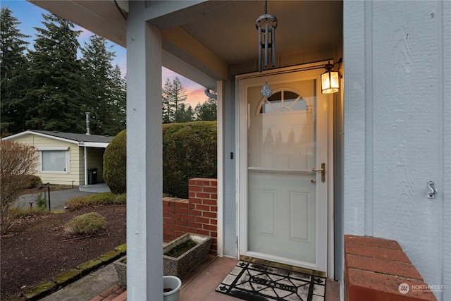 view of exterior entry at dusk