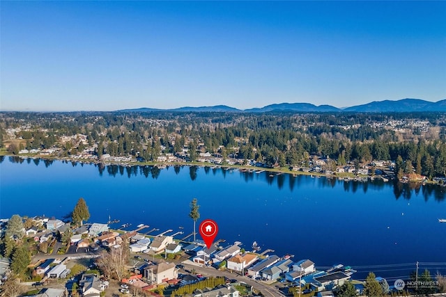 birds eye view of property with a water and mountain view